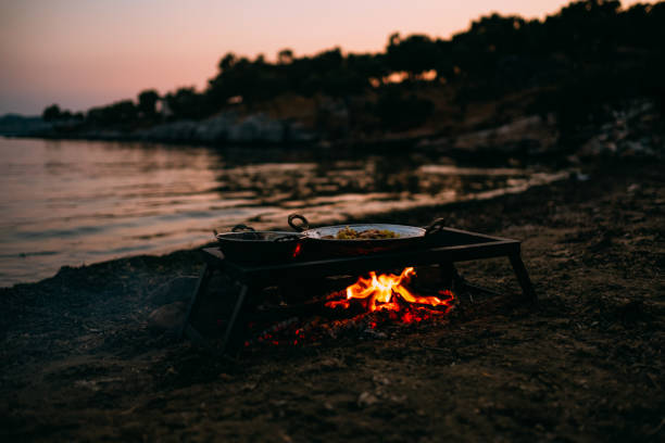 istock Food Cooked on Campfire Burning on the Beach 1156053150