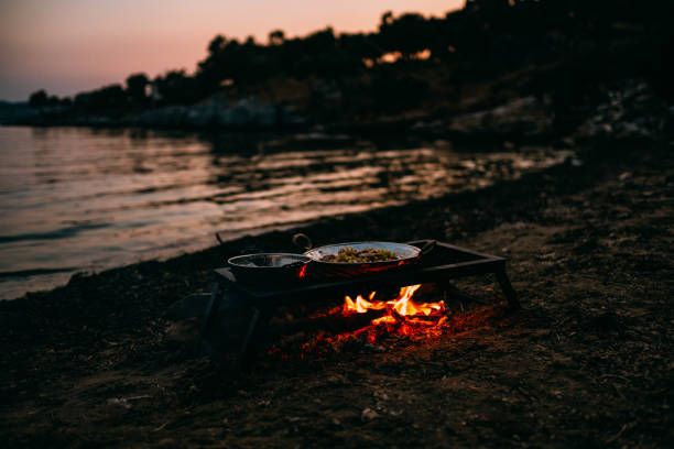 istock Food Cooked on Campfire Burning on the Beach 1156054240