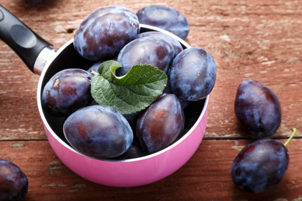 istock ripe plums on the table. 1156057098