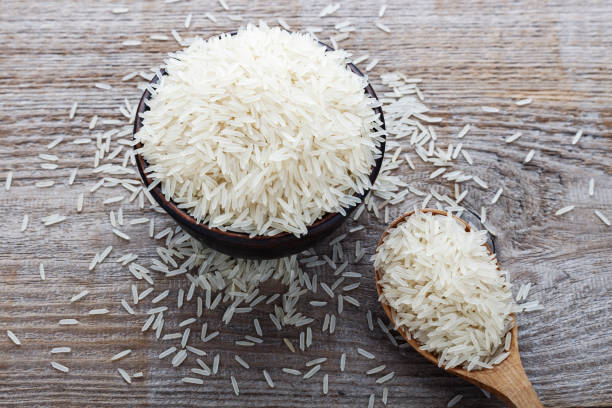 istock food background. white rice in a wooden spoon 1156057166