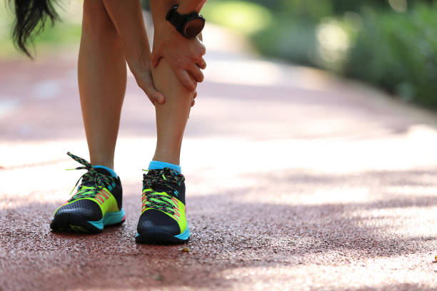 Female runner suffering with pain on sports running injury Female runner suffering with pain on sports running injury shin stock pictures, royalty-free photos & images