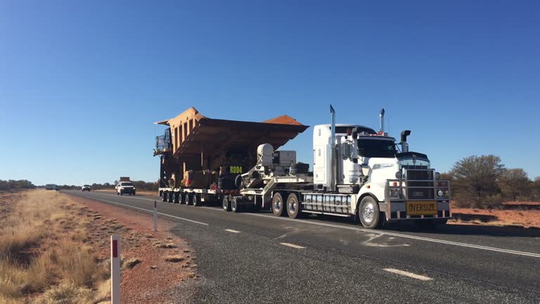 Oversize vehicle convoy on Stuart highway in the red center of Australia outback