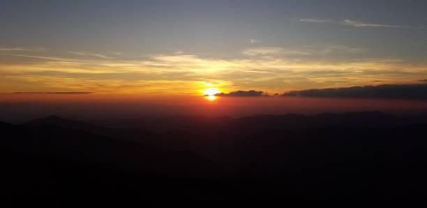 istock Mountain valley in a mist at the sunset - Stock image 1156059891