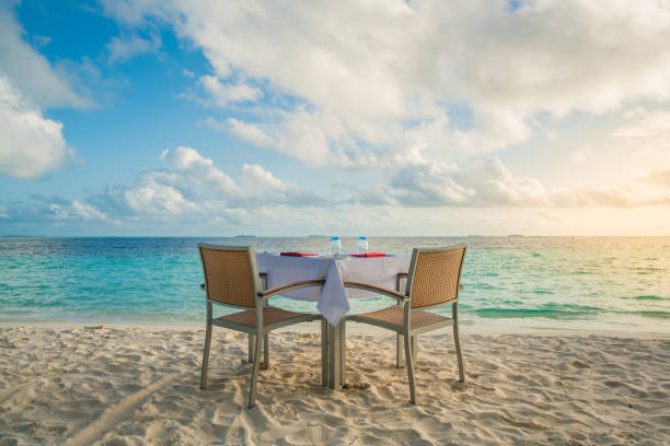 istock Table outdoor next to sea scenic prepare for special romantic dinner time with sunlight shading 1156060040