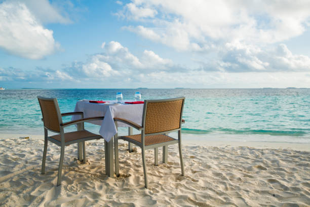 istock Table outdoor next to sea scenic prepare for special romantic dinner time. 1156060042