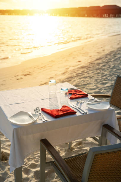 istock Table outdoor next to sea scenic prepare for special romantic dinner time with sunlight shading 1156060045
