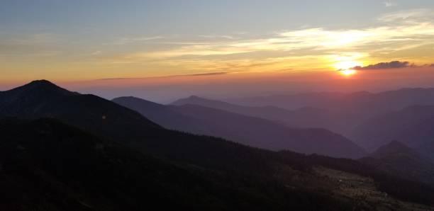 istock Mountain valley in a mist at the sunset - Stock image 1156062197