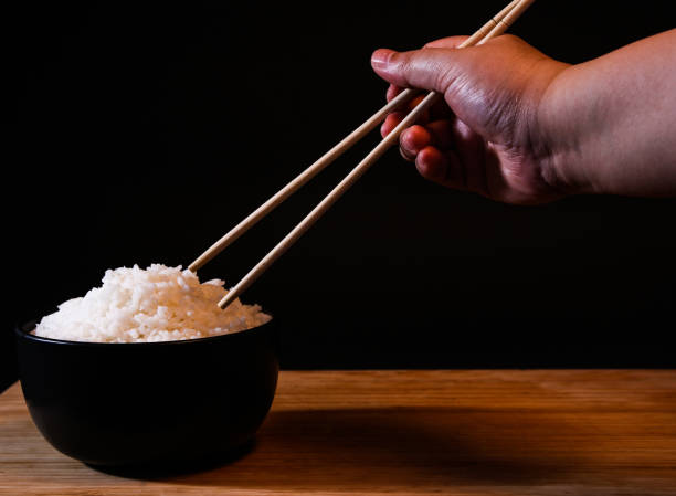 istock Rice in a bowl on a black background in the studio 1156062421