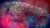cloud of multicolored particles in the air like sparkles on a dark background with depth of field. beautiful bokeh light effects with colored particles. background for holiday presentations. 61
