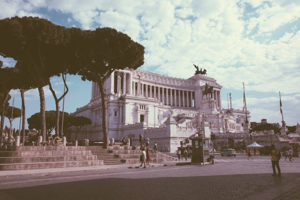Rome, Italy - June 19, 2018: Panoramic front view of museum the Vittorio Emanuele II Monument also known as the Vittoriano or Altare della Patria on Piazza Venezia in Rome. Summer day and blue sky