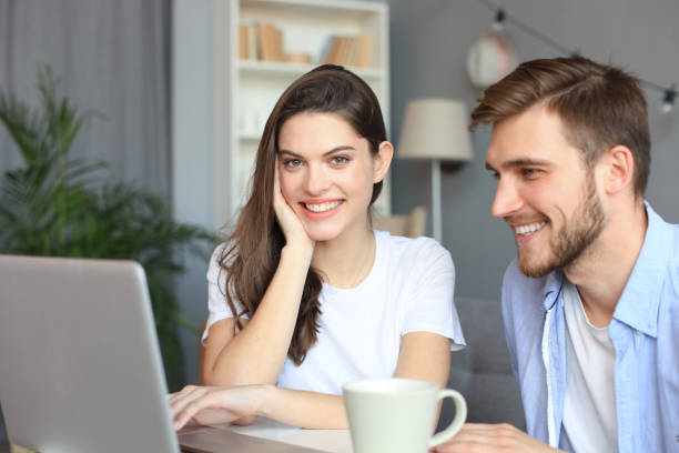 istock Couple pointing while working together on laptop. 1156068842