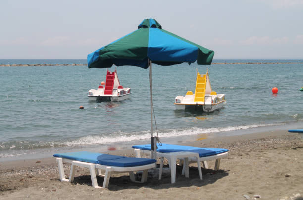 istock Umbrella, sun beds and pedal boats on a beach 1156070268