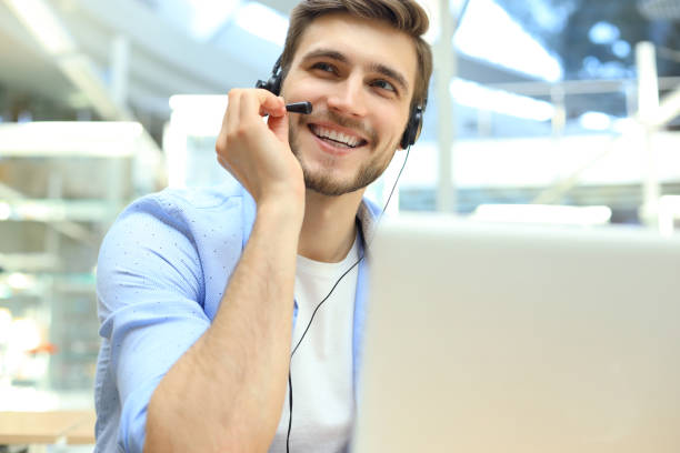 istock Happy young male customer support executive working in office. 1156070370