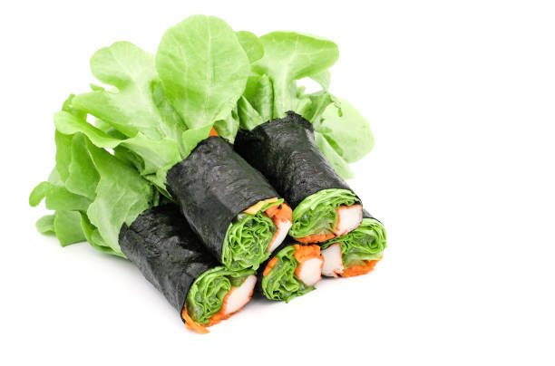 istock Fresh vegetable salad rolls with sheet seaweed isolated on white background 1156080471