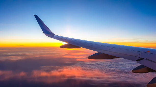 cipro - tramonto visto dall'alto delle nuvole - wing airplane window sunset foto e immagini stock