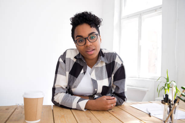 istock Attractive young black woman sitting talking looking at camera 1156082392