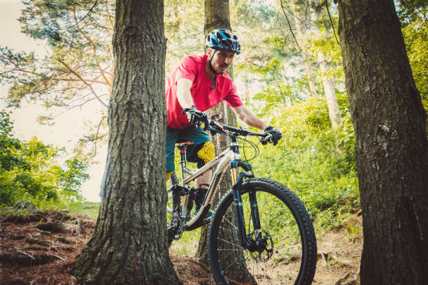 istock Mountain biker riding on bike on forest dirt trail 1156082414