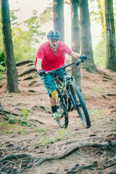 istock Mountain biker riding on bike on forest dirt trail 1156082415