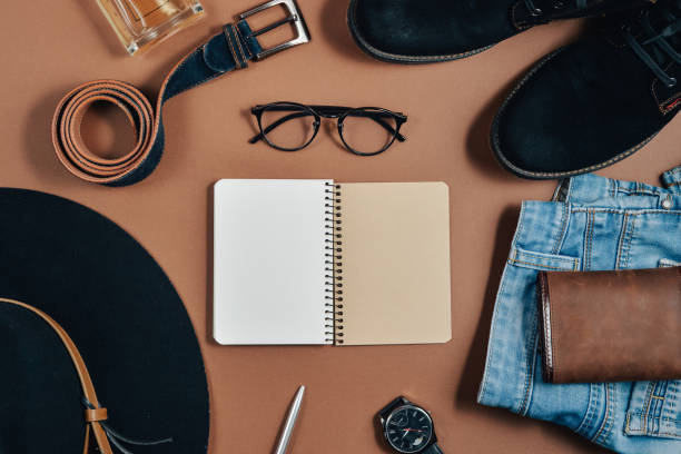 Set of men's blue shoes, tie, belt, glasses, Notepad with pen on white background.