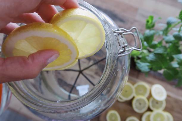 istock Throwing sliced lemons in a jar of water 1156083772