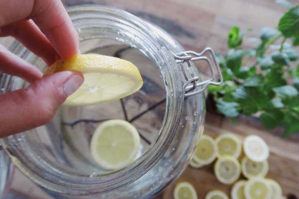 istock Throwing sliced lemons in a jar of water 1156083786