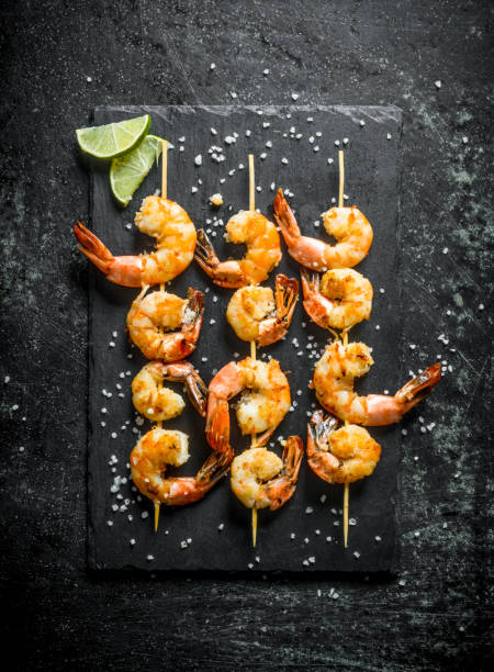 istock Fragrant shrimps grilled on a stone Board. 1156083868