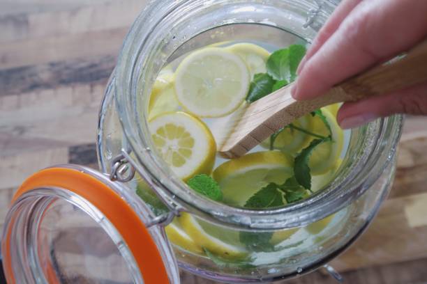 istock Mixing lemons and herbs in water 1156083888