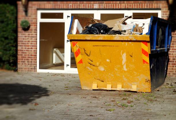Full hired industrial skip filled with rubbish from house clearance