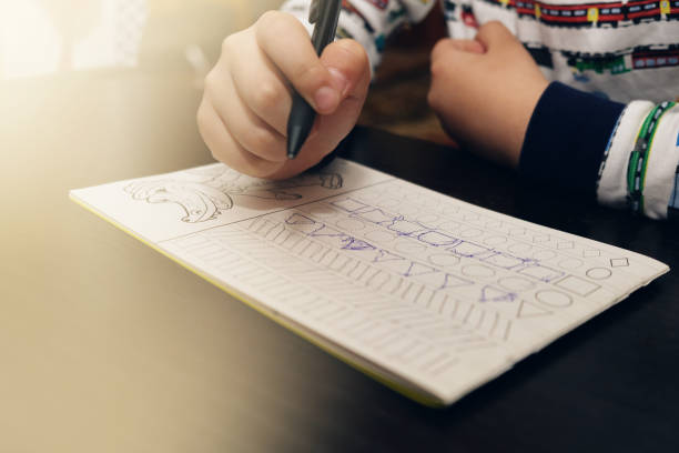 istock 5 years old child writes the recipe at the table 1156084971