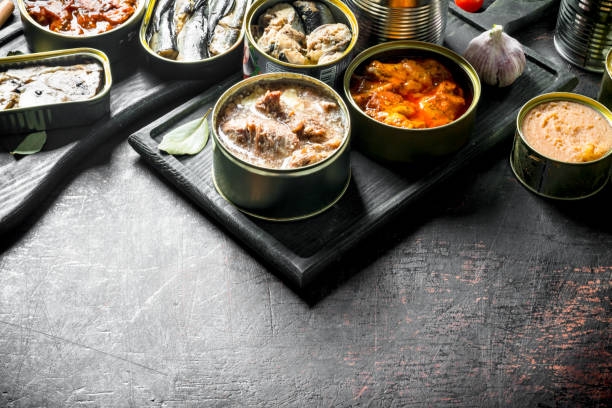 istock Assortment of various canned food in open cans. 1156085331