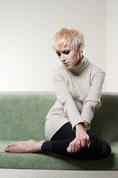 istock Young beautiful sad woman sitting on sofa 115608616