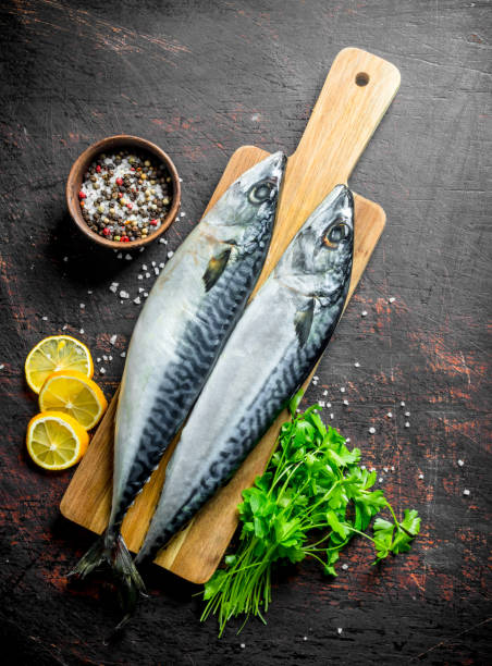 istock Fresh mackerel with herbs, lemon slices and spices. 1156086574