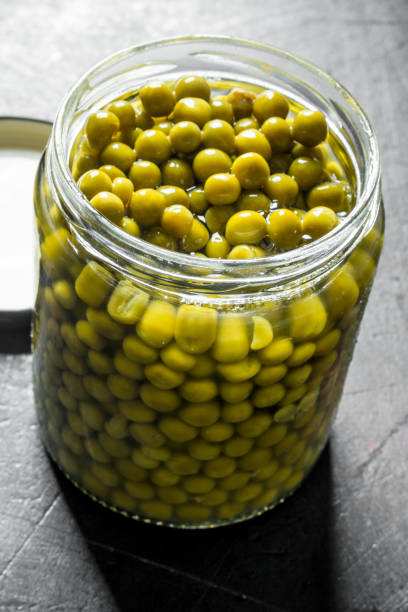 istock Canned green peas in a glass jar. 1156086629