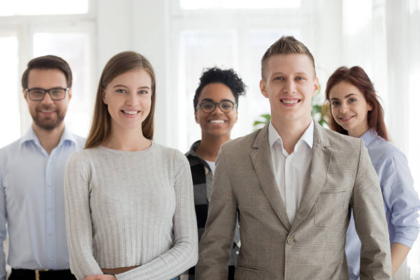 istock Business people standing together looking at camera in office 1156088845