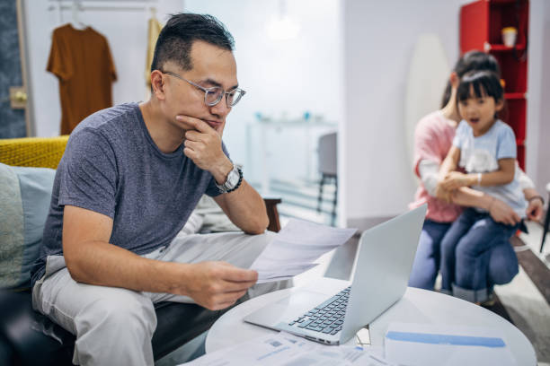 istock Man looking at home finance 1156089156