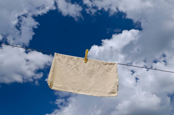 istock Clothes peg on a blue towel and washing line against a blue sky. 1156090395