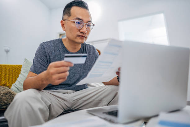 istock Man paying bills with credit card 1156090397