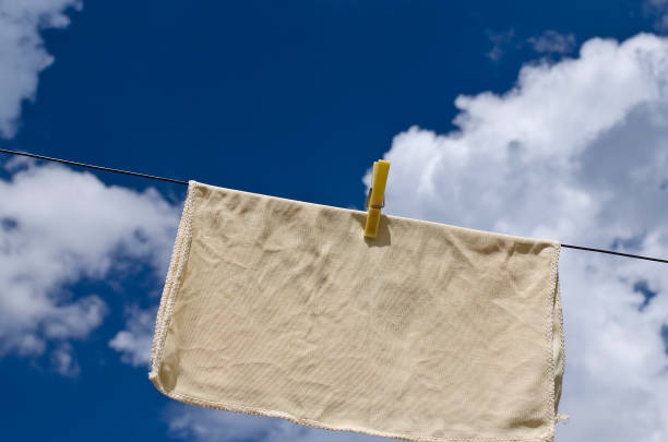 istock Clothes peg on a blue towel and washing line against a blue sky. 1156090426