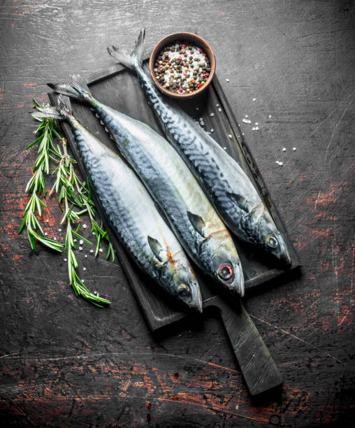 istock Fresh raw mackerel with spices and rosemary. 1156091055