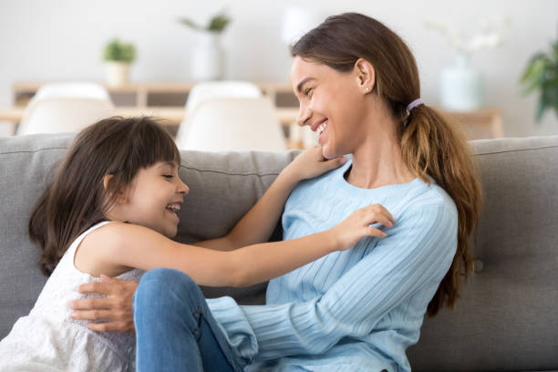 istock Playful mom and daughter relax having fun at home 1156092028