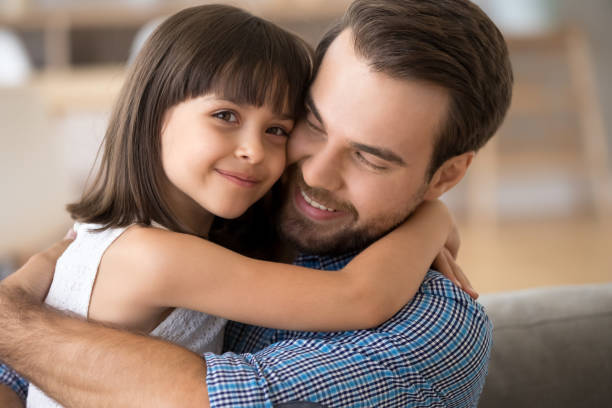 istock Loving dad and daughter hug at home making picture 1156092062