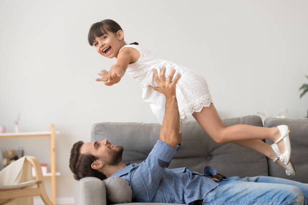 istock Happy dad relax with cute daughter playing game 1156092069