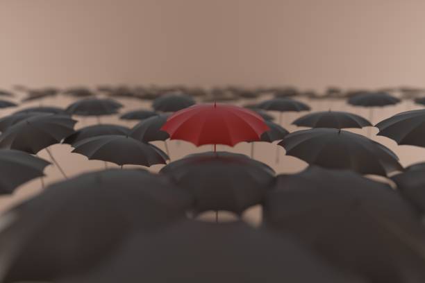 istock Red umbrella stands out among black umbrellas 1156093140
