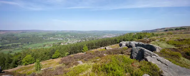 panoramic summer view from Ilkley moor in Yorkshire of open countryside with the market town of Ilkley located in the valley.