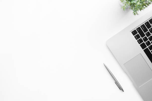 istock White office desk table with laptop computer and pen. Top view with copy space, flat lay. 1156093983