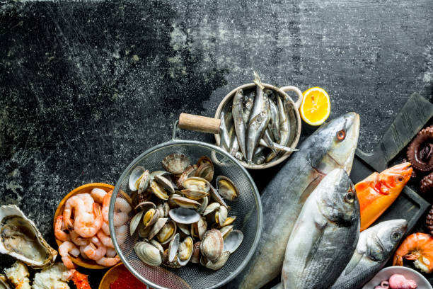 istock Fish on a cutting Board with oysters and shrimp. 1156095747