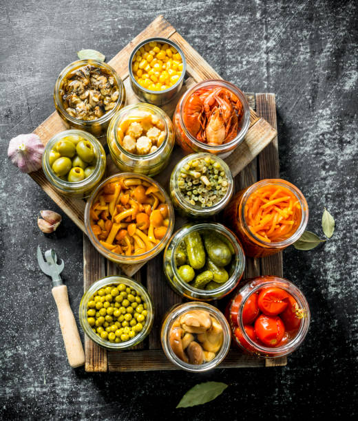 Different preserved food on a wooden tray.