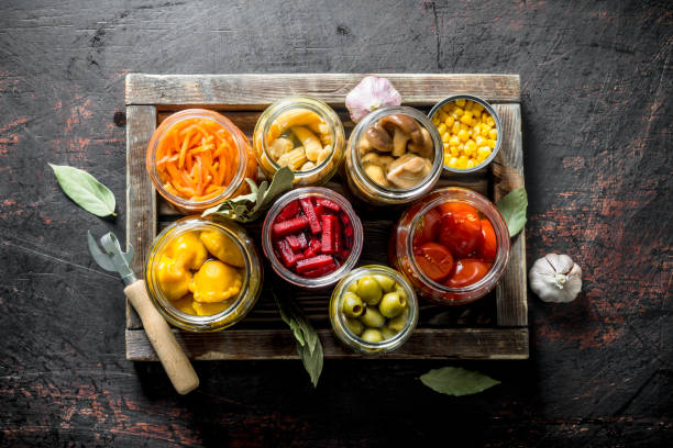 istock Various preserved vegetables on wooden tray. 1156097671