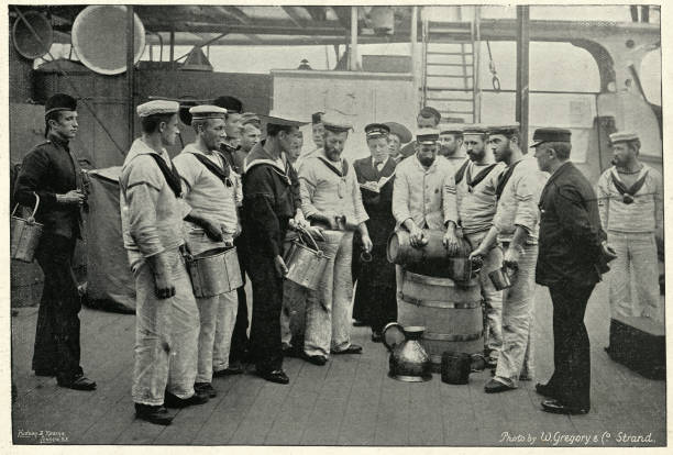Royal navy sailors receving a ration of Grog (Rum), 1895 Vintage photograph of Royal navy sailors receving a ration of Grog on board HMS Royal Sovereign, 19th Century navy photos stock pictures, royalty-free photos & images