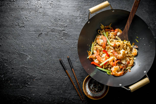 istock Fragrant Asian Udon noodles in a wok pan. 1156100019